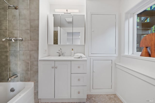 full bathroom with tile walls, vanity, and shower / bathing tub combination