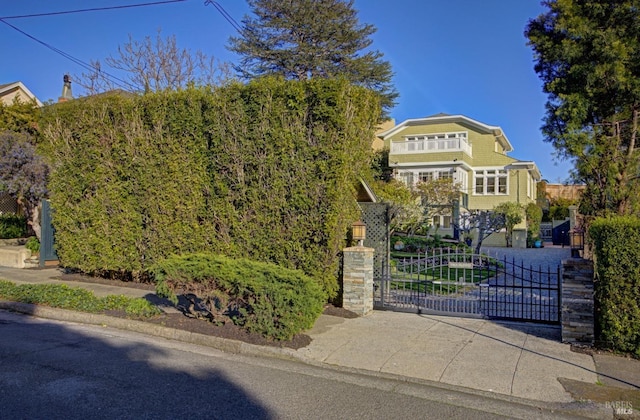 obstructed view of property with fence and a gate