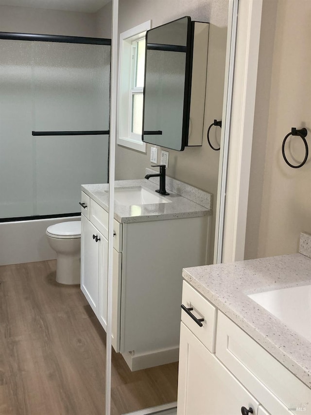 680 N State St, Ukiah, CA 95482 - bathroom with toilet, two vanities, wood finished floors, and a sink