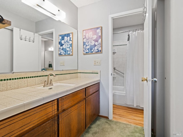 bathroom featuring shower / bathtub combination with curtain and vanity