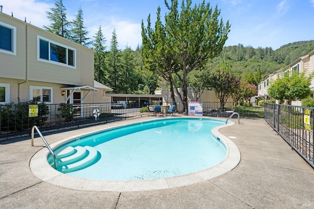 pool featuring a patio and fence