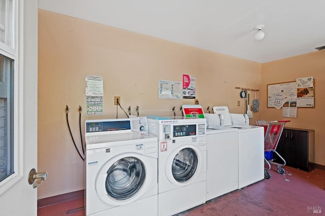 common laundry area featuring visible vents and separate washer and dryer