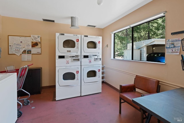 common laundry area with baseboards and stacked washer and clothes dryer