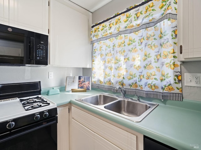 kitchen featuring white cabinetry, black appliances, light countertops, and a sink