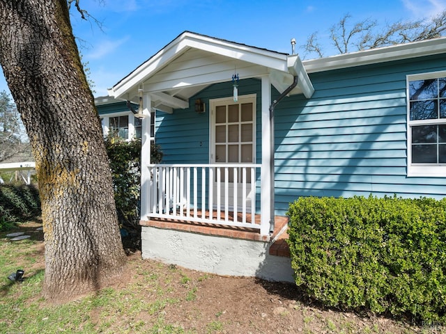 view of exterior entry with a porch