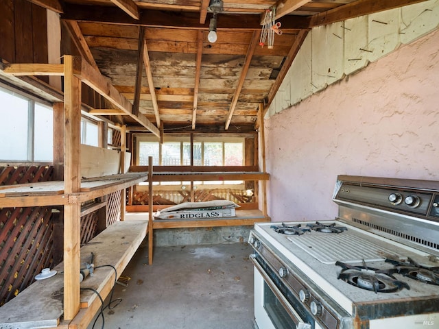 kitchen featuring gas range and concrete flooring