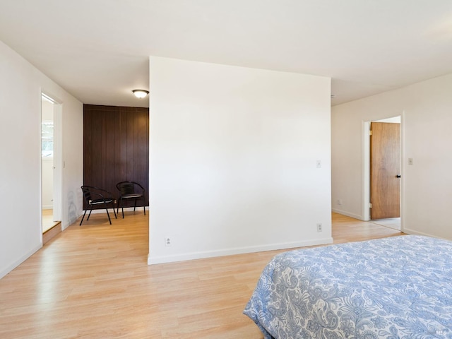 bedroom featuring light wood-style floors and baseboards