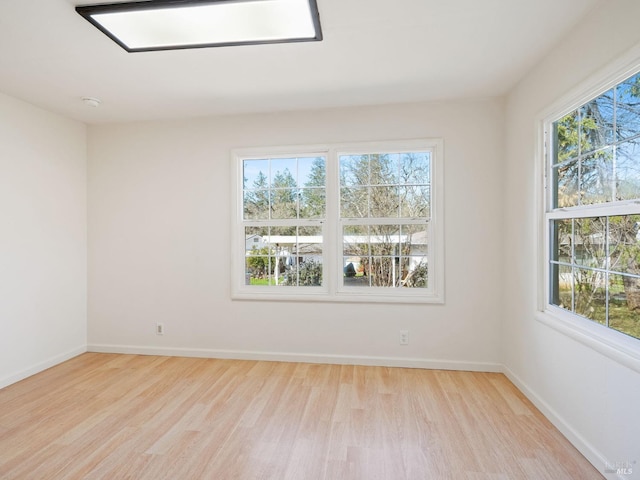 empty room with wood finished floors and baseboards