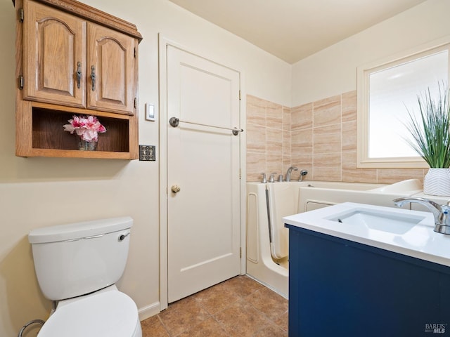 bathroom featuring a sink, toilet, and a bath