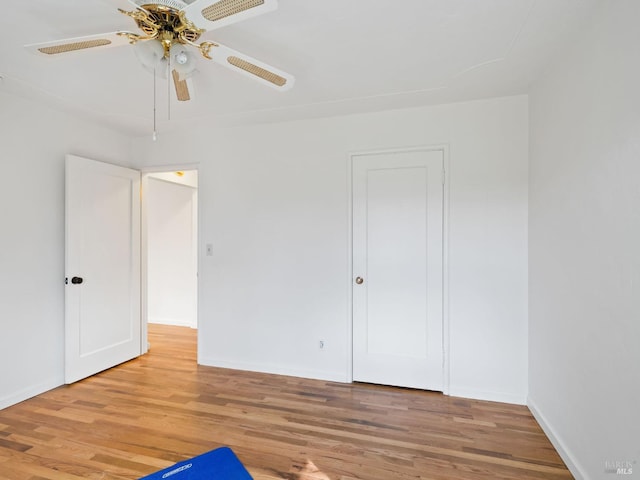 unfurnished bedroom with baseboards, light wood finished floors, and ceiling fan