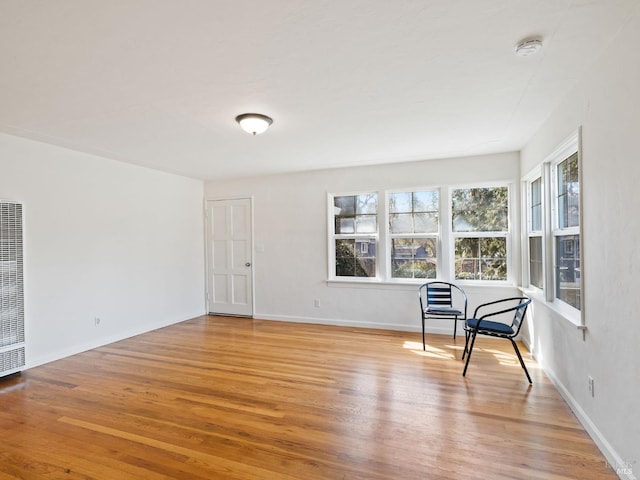 living area featuring light wood-type flooring and baseboards