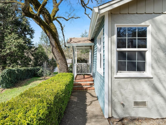 view of home's exterior featuring board and batten siding and stucco siding