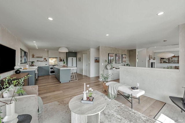 living area with recessed lighting and light wood-type flooring