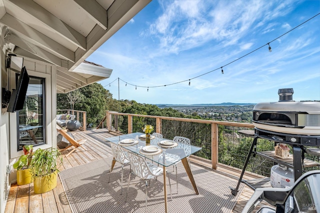 wooden terrace with outdoor dining area