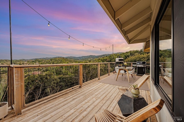 wooden deck featuring area for grilling and a mountain view