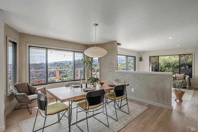 dining area featuring recessed lighting, light wood-type flooring, and baseboards