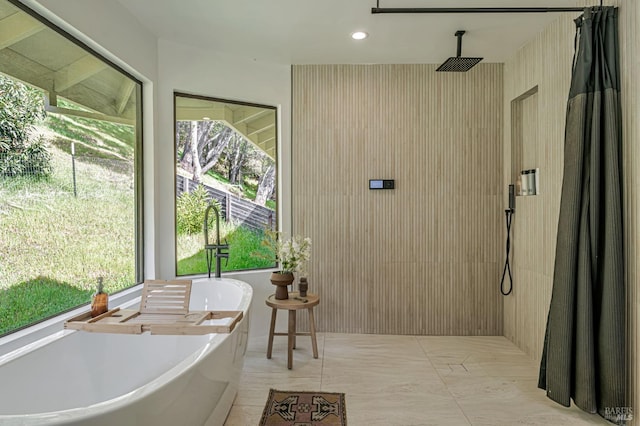 bathroom featuring recessed lighting, a freestanding bath, and walk in shower