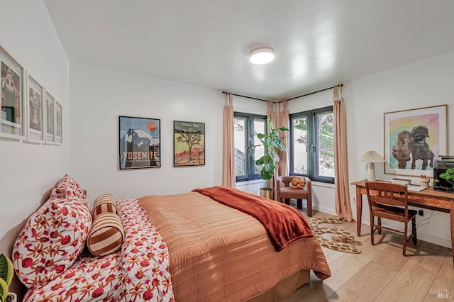 bedroom featuring light wood-style flooring and baseboards