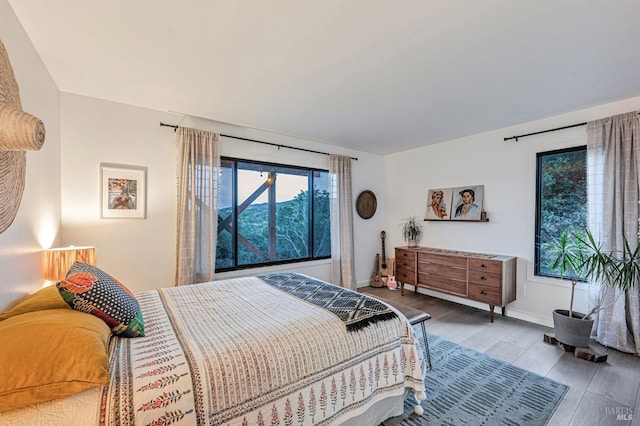 bedroom featuring wood finished floors and baseboards