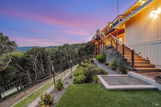 view of yard featuring stairs and fence