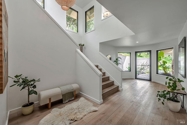 entryway featuring recessed lighting, baseboards, stairs, and hardwood / wood-style flooring