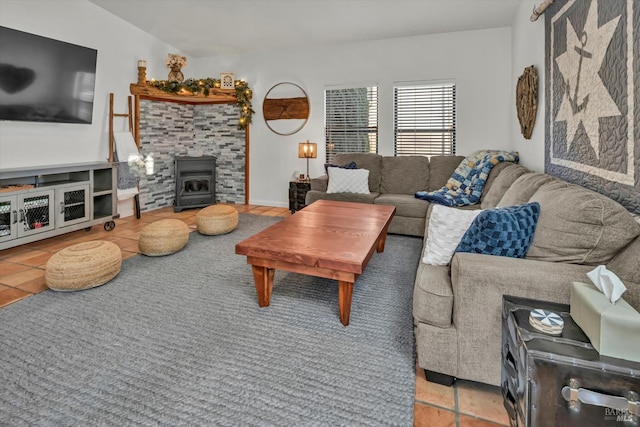 living room featuring tile patterned floors and a wood stove