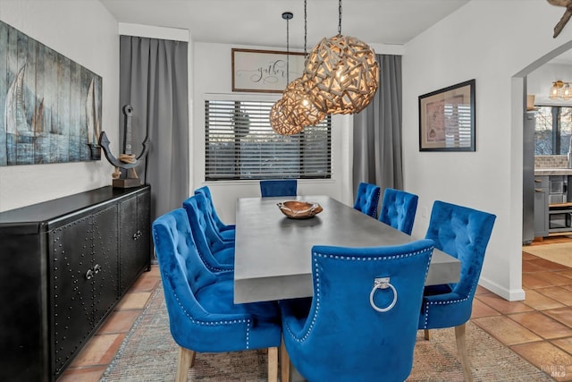 dining space with an inviting chandelier and tile patterned floors