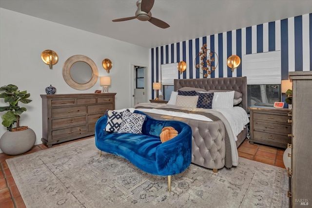 tiled bedroom featuring wallpapered walls, an accent wall, and ceiling fan