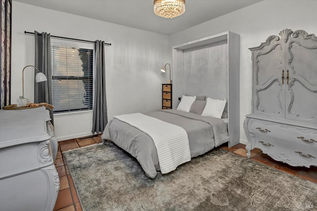 tiled bedroom with a notable chandelier