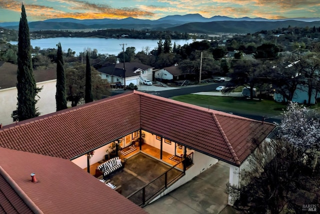 aerial view featuring a water and mountain view