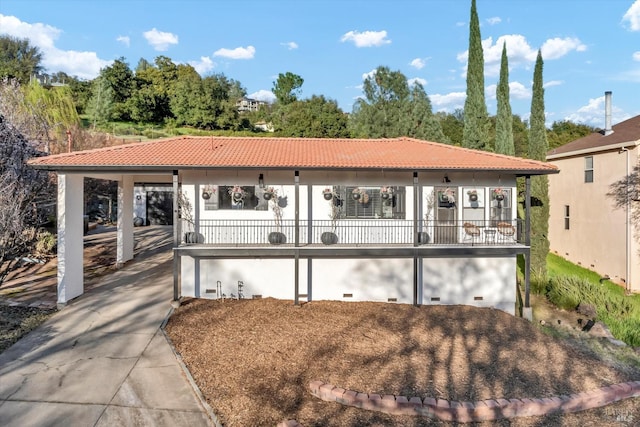 mediterranean / spanish house with crawl space and a tile roof