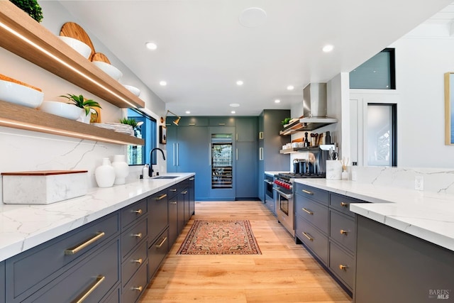 kitchen featuring a sink, open shelves, extractor fan, and high end stove