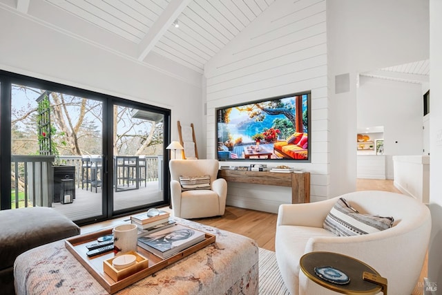 sitting room featuring beam ceiling, high vaulted ceiling, wood ceiling, and wood finished floors