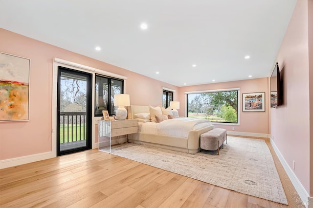 bedroom with access to exterior, recessed lighting, baseboards, and light wood-style floors