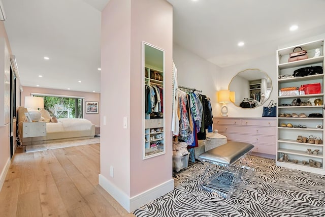 spacious closet with light wood finished floors