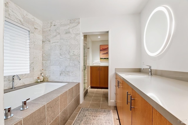 full bath featuring vanity, a shower stall, a bath, and tile patterned floors