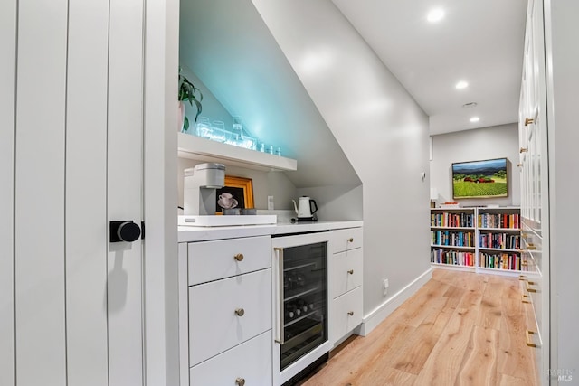 bar with recessed lighting, baseboards, wine cooler, and light wood-style flooring