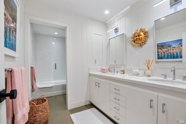 bathroom with a sink, bathing tub / shower combination, and double vanity