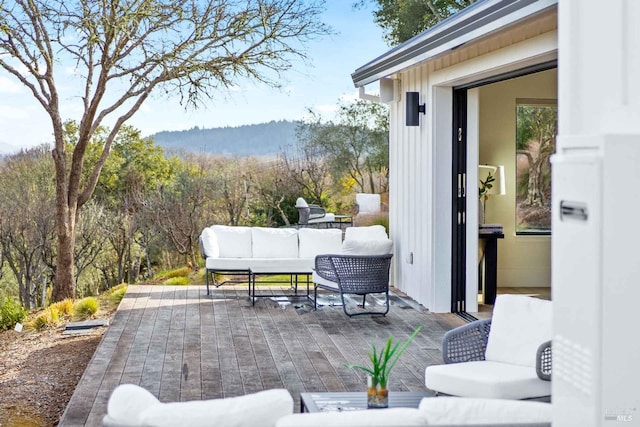 view of patio featuring outdoor lounge area and a view of trees