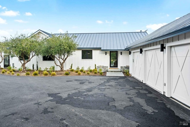 view of building exterior with driveway and a garage