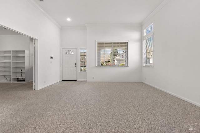 foyer entrance with crown molding, recessed lighting, baseboards, and light carpet