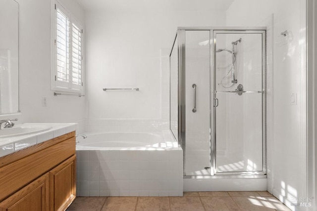 bathroom with vanity, a bath, a stall shower, and tile patterned flooring