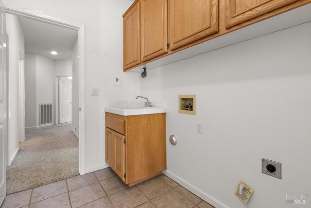 clothes washing area with visible vents, washer hookup, cabinet space, hookup for an electric dryer, and a sink