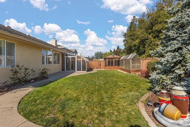 view of yard featuring a patio area, an outbuilding, and fence