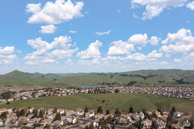 drone / aerial view with a residential view and a water and mountain view