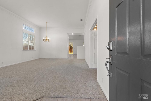 carpeted foyer entrance with a chandelier, visible vents, crown molding, and baseboards