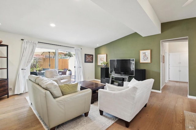 living area with lofted ceiling with beams, light wood-style flooring, and baseboards