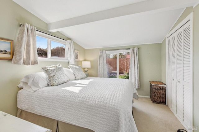 bedroom with a closet, carpet flooring, vaulted ceiling with beams, and baseboards