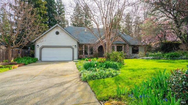 view of front facade with driveway, a front lawn, a garage, and fence