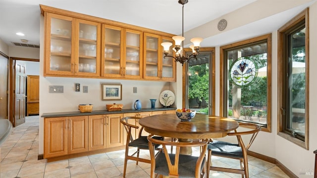 dining area featuring an inviting chandelier, light tile patterned floors, baseboards, and visible vents